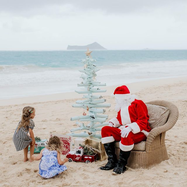 Santa Claus with kids on the beach