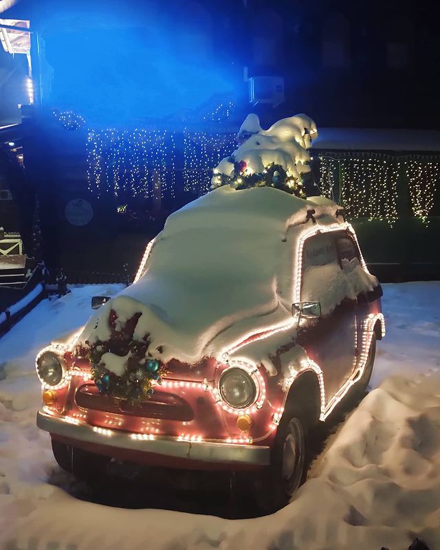 Christmas car covered with snow